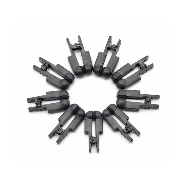 Three conductive stimulation clamps arranged on white studio background